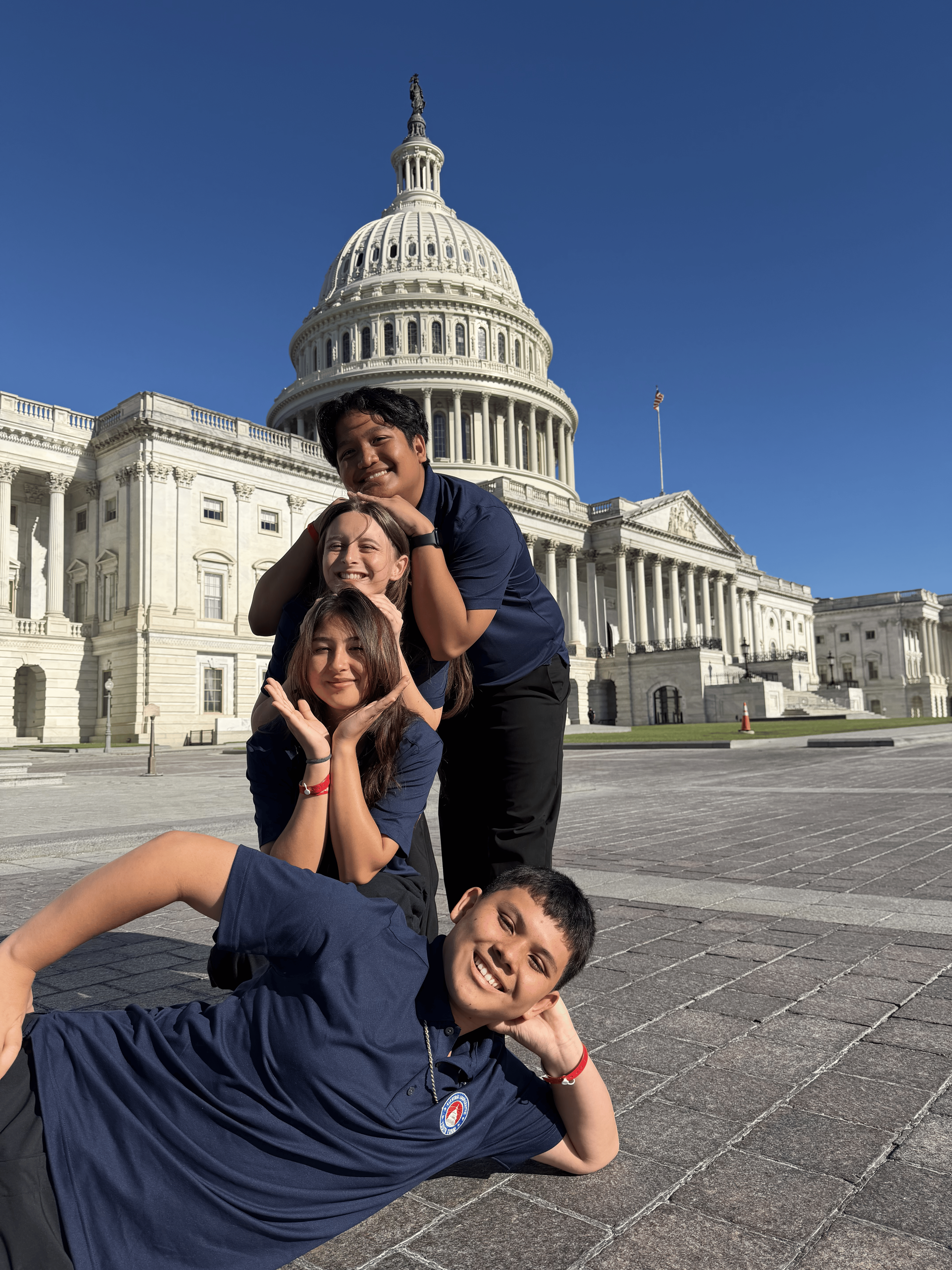4 teens in front of the US Capitol smiling
