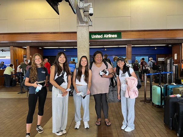 Youth Tour Delegates and Public Affairs Specialist Shelley Paik at Līhuʻe airport awaiting departure.
