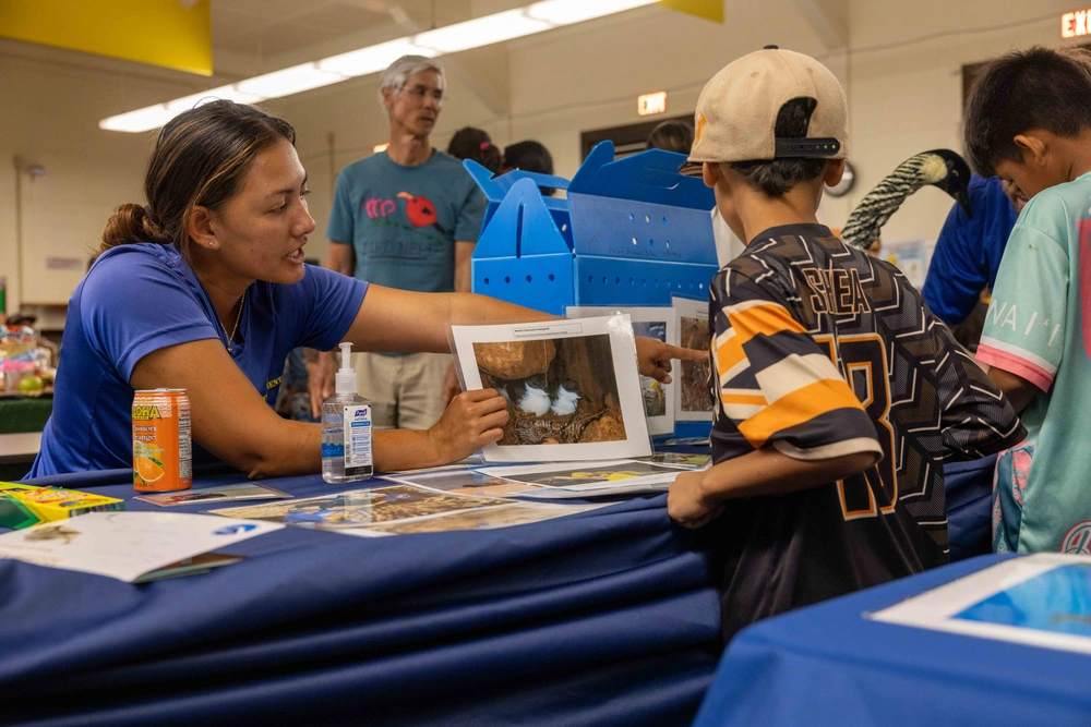 Woman teaching a student about seabirds.