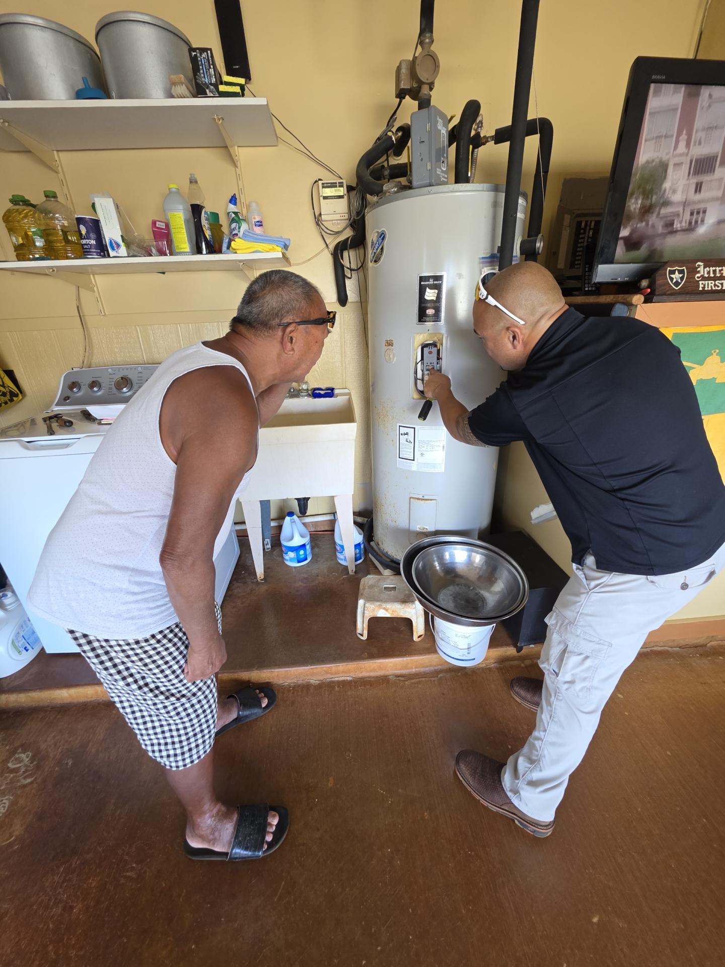 two men looking at a water heater