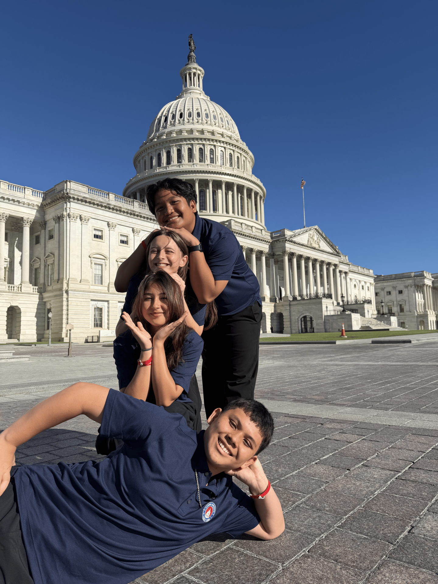 4 teens in front of the US Capitol smiling